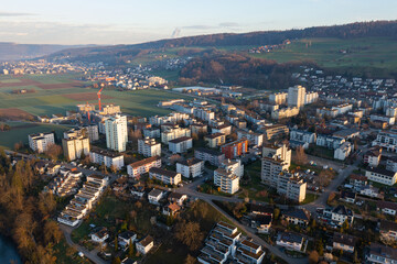Fototapeta na wymiar Drone snapshot over a small village with a river called Limmat on a spring morning.