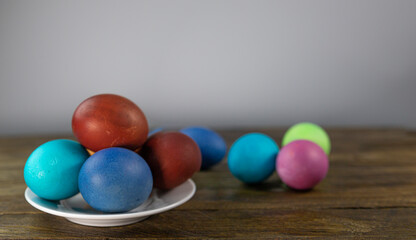 Easter card. Multicolored eggs in a saucer