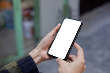 cell phone blank white screen mockup.hand holding texting using mobile on desk at office.background empty space for advertise.work people contact marketing business,technology