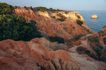 Fototapeta na wymiar Natural formations in the seven valleys trek along most famous beaches in the Algarve region of Portugal. This place is in la Marina beach at sunset.