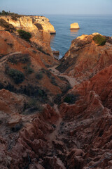 Fototapeta na wymiar Natural formations in the seven valleys trek along most famous beaches in the Algarve region of Portugal. This place is in la Marina beach at sunset.