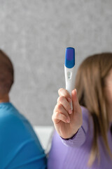Negative pregnancy test in the hands of a young woman. Conscious denial of pregnancy, childfree....