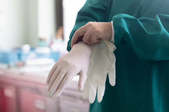 Doctor Putting On Surgical Gloves , Professional Medical Safety And Hygiene For Surgery And Medical Exam.