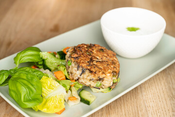 Rice patty with fresh basil, cucumber and carrots, salt with a creamy cheeky dip with mint leaves