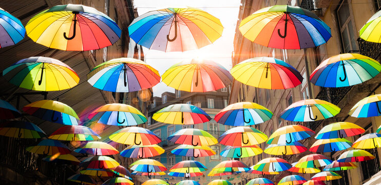 Street with umbrellas in LGBT colors for gay pride day