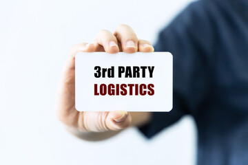 Third party logistics text on blank business card being held by a woman's hand with blurred background. Business concept about logistics.
