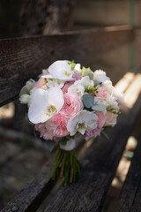 The bride holds a wedding bouquet of white orchids. Wedding decor ideas