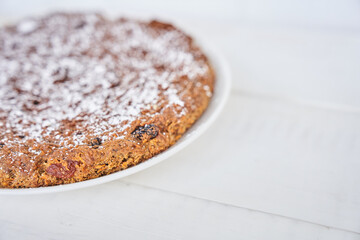 Part of a carrot and raisin pie. The pie is gluten-free, milk-free and egg-free. Selective focus, space for text. Diet dessert. The concept of healthy eating. High quality photo