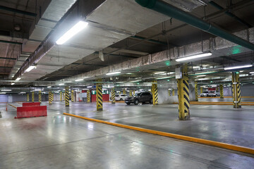 Selective focus of underground parking in a shopping mall. Parking restrictions. With a space to copy. Navigation in the parking lot. Free parking space. High quality photo