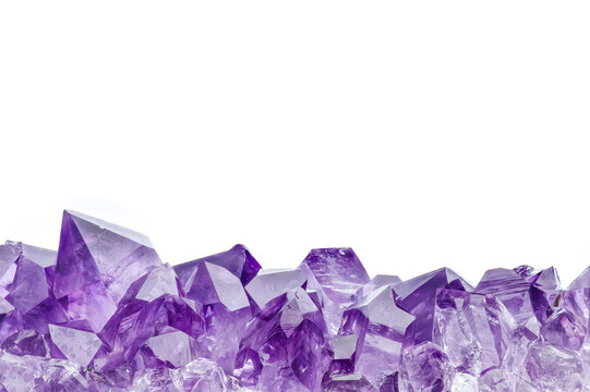 amethyst druse isolated on white background. macro detail texture background. close-up raw rough unpolished semi-precious gemstone
