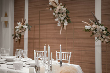 Wedding table set up in boho style with pampas grass and greenery, soft focus