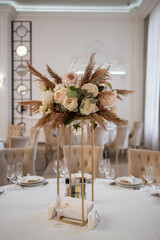 Boho wedding decor. Wedding centerpieces arrangements with dried flowers floristry and candles, boho style.