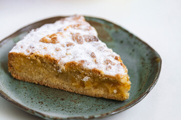 tasty pie in ceramic plate on white wooden desk