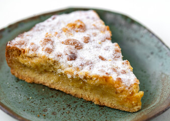 tasty pie in ceramic plate on white wooden desk