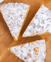 Three pieces of pie in wooden desk on white background, top view.