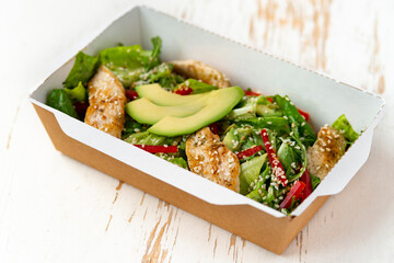 Healthy chicken salad with avocado,in package for take away or food delivery.