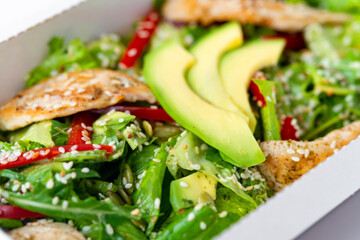 chicken salad with avocado in a Take away box. Healthy lunch