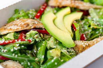 Healthy chicken salad with avocado,in package for take away or food delivery.