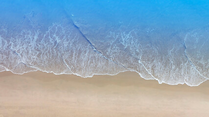 Aerial view with beach in wave of  turquoise sea water shot, Top view of beautiful white sand background