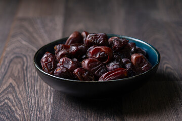 dates and nuts in a bowl on a dark background