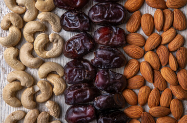 dates and nuts in on a grey wooden background