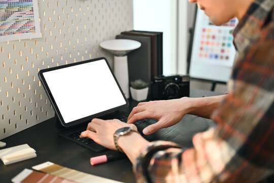 Cropped shot of interior designer using digital tablet, choosing color for creating interior design project in studio