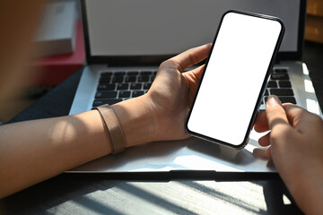 Woman hands using mobile phone, chatting on smartphone, using banking services at office desk. Close up view
