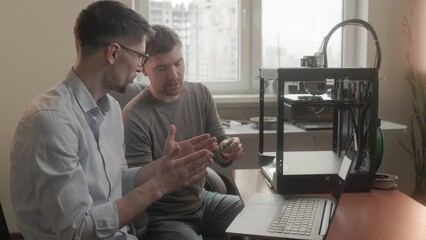 lab engineer cooperating with employee explaining work of 3D dimensional printer. Laboratory teamwork. Electric engineering. Cooperation.