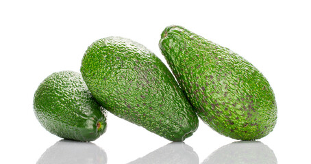 Three dark green ripe organic avocados, macro, isolated on white background.