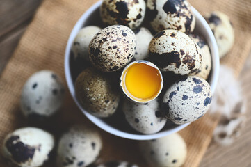 quail eggs on bowl, fresh quail eggs on wooden table background, raw eggs with peel egg shell