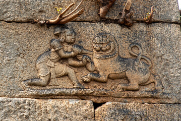 Bas-relief of a warrior fighting a lion in the royal enclosure in Hampi