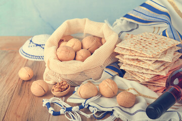 Passover celebration concept. Matzah, red kosher and walnut. Traditional ritual Jewish bread...