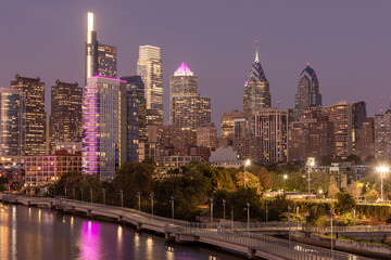 Philadelphia Downtown skyline at Night with the Schuylkill river. Beautiful Sunset Light. Schuylkill River Trail in Background. City skyline glows under the beautiful sunset light. Cityscape. PA, USA.