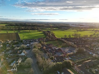Farmers' fields at sunset with long shadows from the trees