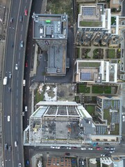 Looking down at the city below - vertical drone aerial shot of highways, roads and buildings