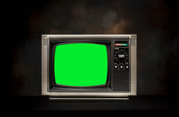 Retro old television (TV) with chroma key green screen for designer on the black background.