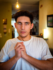 Naklejka premium Surprised, scared, frightened, unsure handsome young man