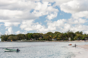 Fototapeta na wymiar Ocean in Barbados with Yacht and Boats. Beach with Local Fisherman. Caribbean Island