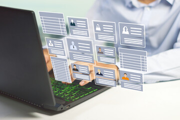 HR officer working on a laptop with employee data to manage payroll , holiday leave and recruit...