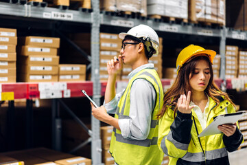 Asian two engineer team shipping order detail on tablet check goods and supplies on shelves with goods background inventory in factory warehouse.logistic industry and business export