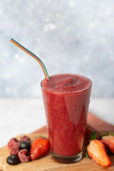 Mixed berry smoothie garnished with fresh fruit