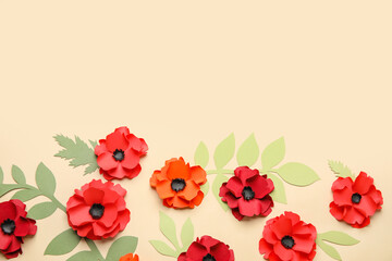 Paper poppy flowers with leaves on beige background