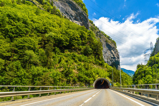 Road among Alps mountains with a toonel in a rock, Klosters-Serneus, Davos, Graubuenden Switzerland