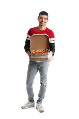 Young man with boxes of tasty pizza on white background