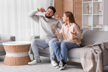 Young couple suffering from loud noise at home