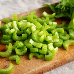 Raw Green Organic Celery on a rustic wooden board, side view. Close-up.