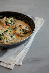 Homemade Creamy Tuscan Chicken with Spinach in a Pan, low angle view. Copy space.