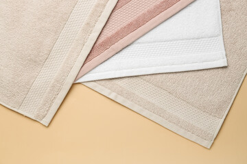 Folded soft towels on beige background