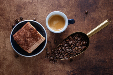 Obraz na płótnie Canvas Espresso with beans and tiramisu cake