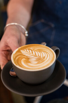flat white with pretty coffee art rosetta